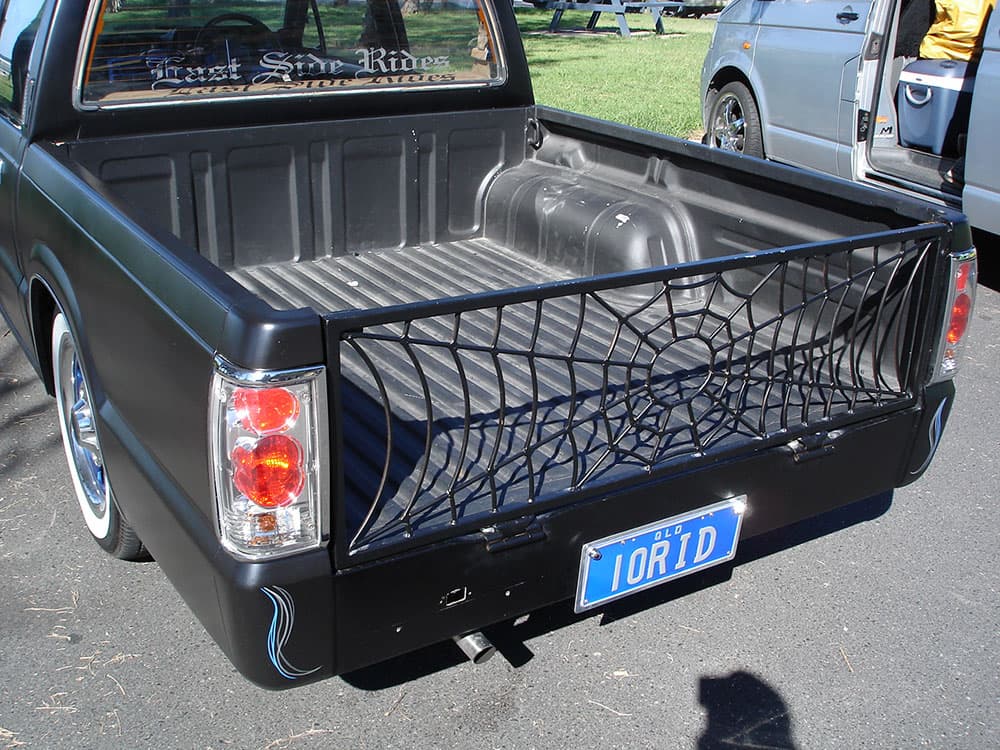 Black custom minitruck bed detail showing East Side Riders graphics and TORID plates with cargo net at Half Way Havoc 2006 Nambucca Heads NSW - Minitruck Show Photos