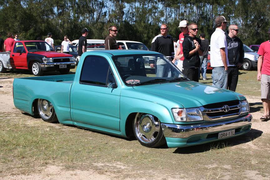 Turquoise slammed Toyota Hilux with extreme lowered stance and chrome wheels at Half Way Havoc