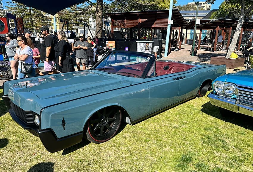 Candy paint lowrider with chrome wire wheels at 2023 lowrider event