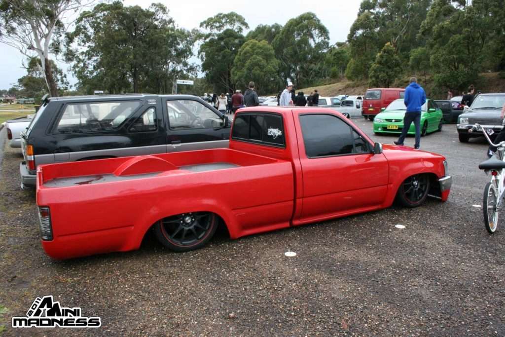 Bright red slammed minitruck with black wheels at outdoor Mini Madness 2011 NSW
