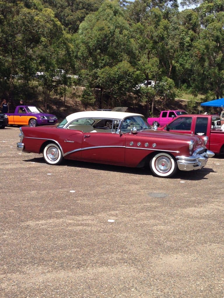 Burgundy 1955 Buick Century hardtop with white wall tires and chrome ventiports at Mini Madness 2014