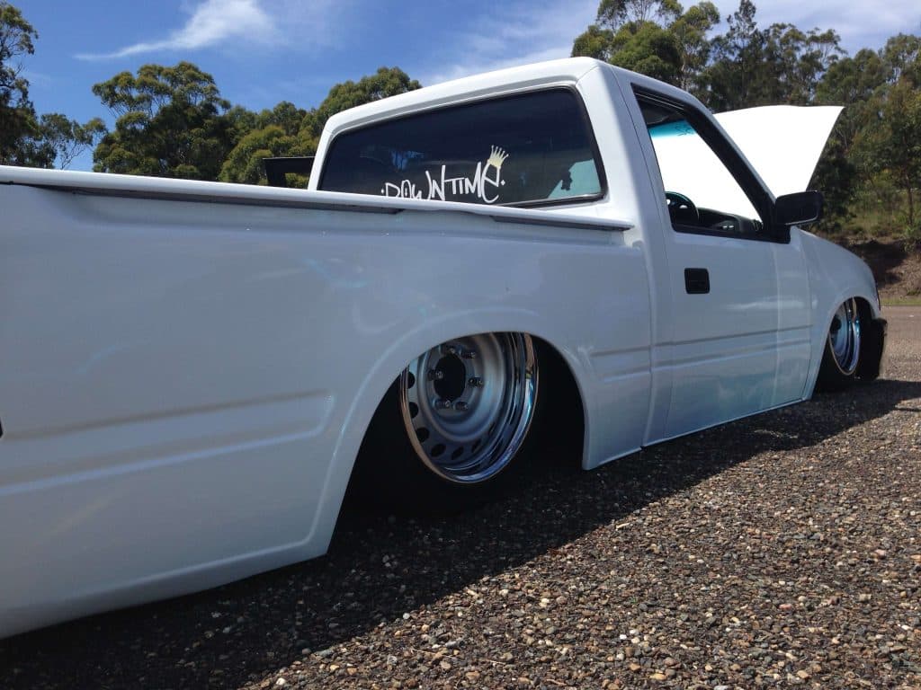 White minitruck with DOWNTIME decal and extremely wide reverse mount wheels at Port Macquarie raceway